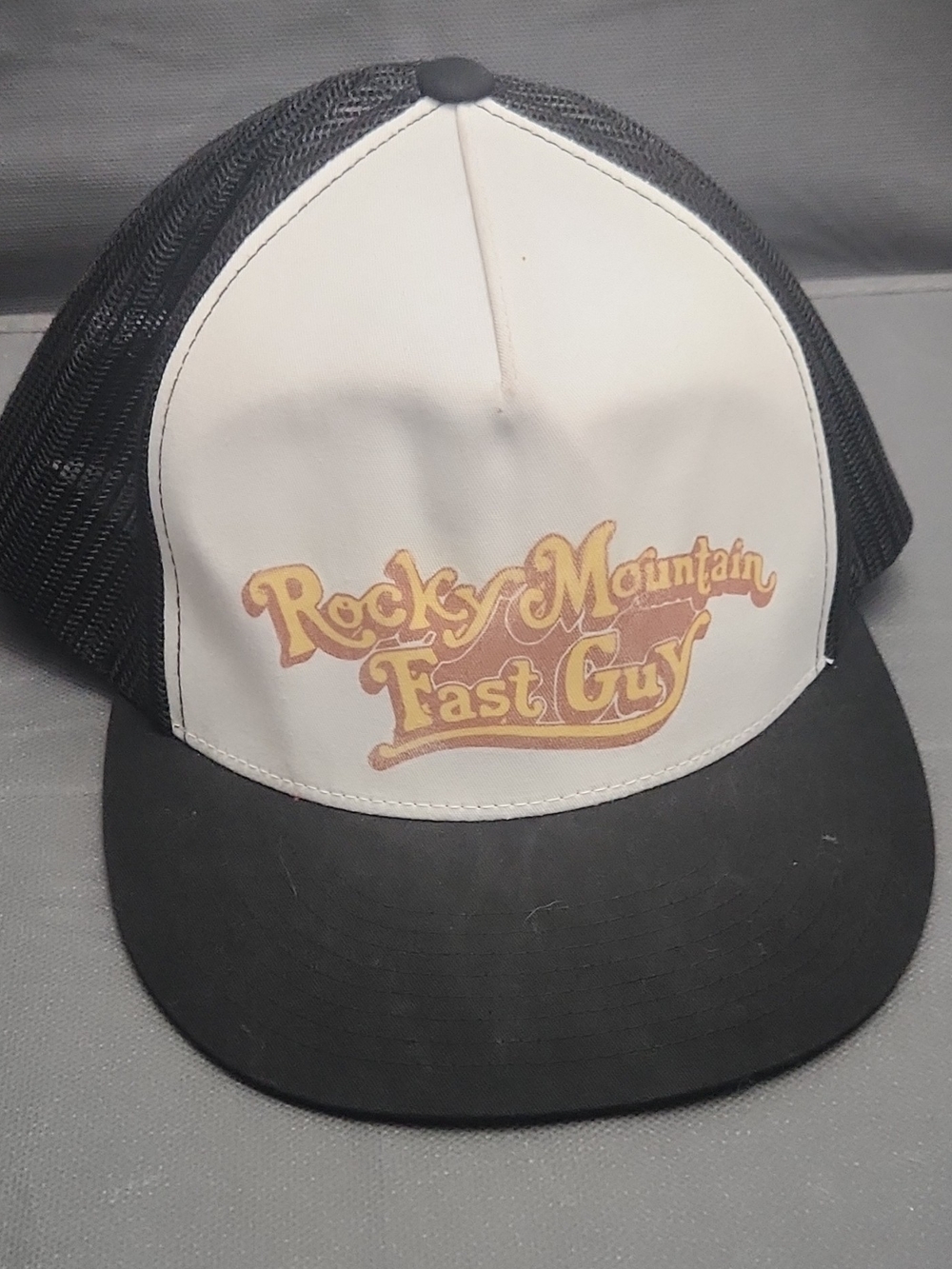 The Classic Black & White Trucker Hat with Yellow Logo
